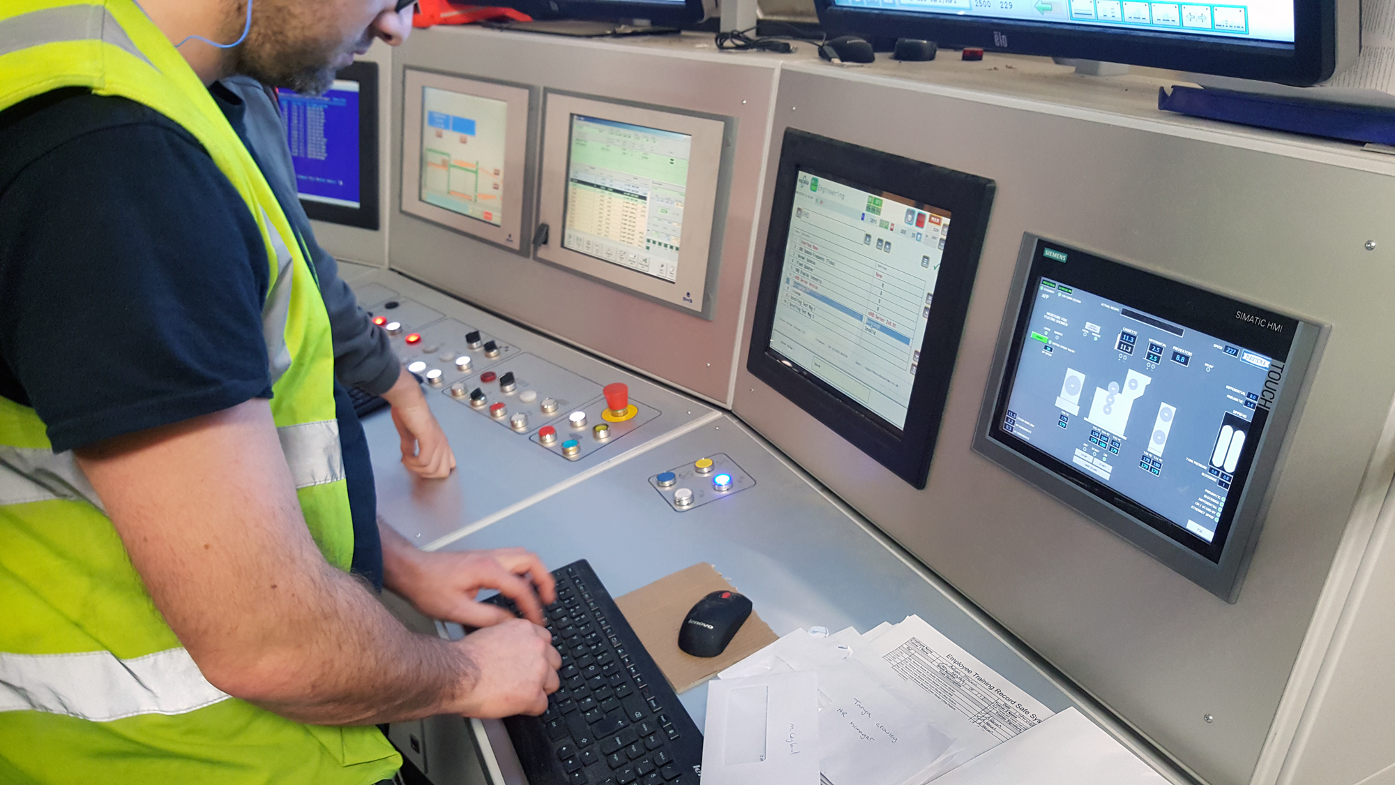 Operative at a corrugator desk